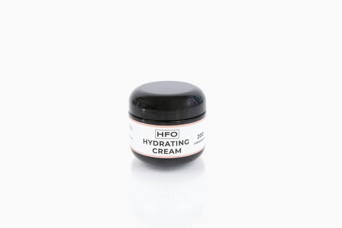 Woman applying hydrating cream butter body very dry to cracked elbows